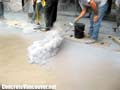 Dusting the concrete surface with powdered release, Langley, BC,  Canada