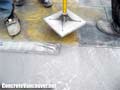 Hand stomping the concrete stamp pattern into concrete, Langley, BC, Canada