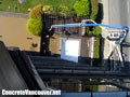 Concrete pump truck loading stamped concrete mix on pool deck in North Vancouver, BC, Canada