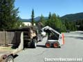 Bobcat loading truck with pavingstones in Whistler, BC, Canada