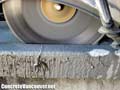 Diamond blade saw-cutting concrete retaining wall coping in Whistler BC, Canada