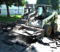 Excavating Asphalt Pavement with Bobcat